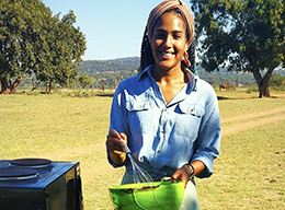 Nada Mays prepares food outside.