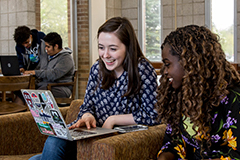 SEU students gathered around computer